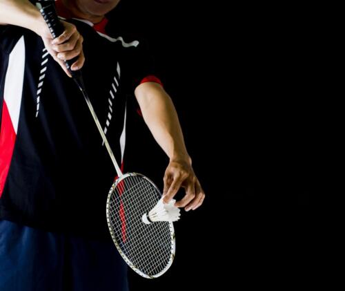 player holding the badminton racket and shuttle cock